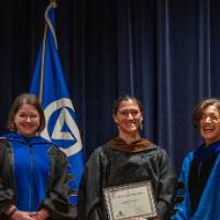 Provost Mili laughs as she takes picture with 2 women
